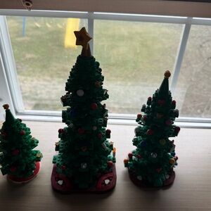Three assembled Lego Christmas trees. Original box not included.